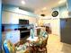 Bright kitchen with tile floors, stainless steel appliances, and breakfast nook at 24132 Buckingham Way, Punta Gorda, FL 33980