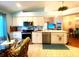 Modern kitchen featuring stainless steel appliances, tile floors, and open layout at 24132 Buckingham Way, Punta Gorda, FL 33980