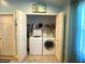 Convenient laundry room with side-by-side washer and dryer, and extra storage at 24132 Buckingham Way, Punta Gorda, FL 33980