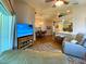 Cozy living room featuring hardwood floors, ceiling fan, and comfortable sofas at 24132 Buckingham Way, Punta Gorda, FL 33980