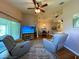 Living room with hardwood floors, recliners, sliding glass door to patio, and open floorplan at 24132 Buckingham Way, Punta Gorda, FL 33980