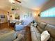 Inviting living room with hardwood floors, comfortable seating, and open floorplan to kitchen at 24132 Buckingham Way, Punta Gorda, FL 33980