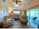 Spacious living room featuring comfortable seating and lots of natural light at 24132 Buckingham Way, Punta Gorda, FL 33980