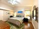 Inviting main bedroom with vaulted ceiling, featuring hardwood floors and ample natural light at 24132 Buckingham Way, Punta Gorda, FL 33980