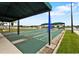 Outdoor shuffleboard courts with covered seating offer recreational activities and a view of the surrounding community at 24132 Buckingham Way, Punta Gorda, FL 33980