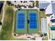 Aerial view of dual fenced-in tennis courts and bocce ball courts within the community at 24132 Buckingham Way, Punta Gorda, FL 33980