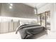 Modern bedroom with decorative lighting, closet, and elegant gray bedspread at 24317 Treasure Island Blvd, Punta Gorda, FL 33955