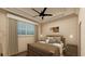 Cozy bedroom with large windows, a plush bed, and decorative lighting at 24317 Treasure Island Blvd, Punta Gorda, FL 33955