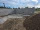 A newly built concrete block foundation is shown in a residential construction site at 24317 Treasure Island Blvd, Punta Gorda, FL 33955