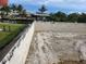 A newly built concrete block foundation is shown in a residential construction site at 24317 Treasure Island Blvd, Punta Gorda, FL 33955