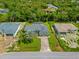 Aerial view of a charming home with lush landscaping and a well-maintained lawn at 2455 Jacoby Cir, North Port, FL 34288