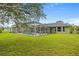 Lush backyard featuring a screened pool enclosure with clear views and ample space for outdoor activities at 2455 Jacoby Cir, North Port, FL 34288