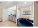 Stylish bathroom features a unique dark blue soaking tub and vanity at 2455 Jacoby Cir, North Port, FL 34288