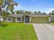 Charming single-story home with a well-manicured lawn and an attached two-car garage at 2455 Jacoby Cir, North Port, FL 34288