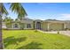 Inviting home with a lush green lawn, arched windows, and a convenient two-car garage at 2455 Jacoby Cir, North Port, FL 34288