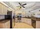 Well-equipped kitchen featuring stainless steel appliances, granite countertops, and ceiling fan at 2455 Jacoby Cir, North Port, FL 34288