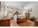 Cozy main bedroom featuring hardwood floors and comfortable furnishings at 2455 Jacoby Cir, North Port, FL 34288