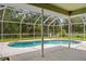 Relaxing screened-in pool area with lounge chairs and a view of the lush greenery at 2455 Jacoby Cir, North Port, FL 34288