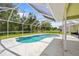 Relaxing screened-in pool area with lounge chairs and a view of the lush greenery at 2455 Jacoby Cir, North Port, FL 34288