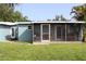 A spacious screened porch offers an outdoor living space and blends seamlessly with the lush backyard at 2513 Ambrose Ln, Port Charlotte, FL 33952