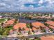 Stunning aerial view of a waterfront townhome featuring a red tile roof and lush tropical landscaping at 2630 Tarpon Cove Dr # 211, Punta Gorda, FL 33950