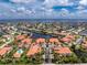 An aerial view, emphasizing the property's access to the water, proximity to a shared pool, and lush, verdant surroundings at 2630 Tarpon Cove Dr # 211, Punta Gorda, FL 33950