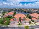 A beautiful townhome with tropical landscaping and a tranquil waterfront view from an aerial perspective at 2630 Tarpon Cove Dr # 211, Punta Gorda, FL 33950