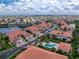 Expansive aerial view of a neighborhood with well-maintained homes, a community pool, lush landscaping, and beautiful waterways at 2630 Tarpon Cove Dr # 211, Punta Gorda, FL 33950