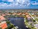 A stunning aerial perspective of a waterfront property with boat docks, lush gardens, and immediate access to open waters at 2630 Tarpon Cove Dr # 211, Punta Gorda, FL 33950