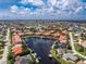 An aerial image showcasing a home on a waterfront property with boat docks, manicured landscaping, and waterway access at 2630 Tarpon Cove Dr # 211, Punta Gorda, FL 33950