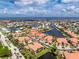 A serene aerial view, showcasing this home's proximity to waterways, a community pool, and lush tropical landscaping at 2630 Tarpon Cove Dr # 211, Punta Gorda, FL 33950