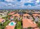 A high-angle shot of a neighborhood, highlighting the home's location near a waterway, lush landscaping, and a neighborhood pool at 2630 Tarpon Cove Dr # 211, Punta Gorda, FL 33950