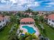 Aerial view showcasing a community pool, clubhouse, and well-maintained landscaping at 2630 Tarpon Cove Dr # 211, Punta Gorda, FL 33950