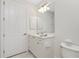 Well-lit bathroom showcases a white vanity with storage and a decorative flower accent at 2630 Tarpon Cove Dr # 211, Punta Gorda, FL 33950