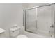 Bright bathroom featuring a shower-tub combo with glass doors and white tile at 2630 Tarpon Cove Dr # 211, Punta Gorda, FL 33950