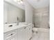 Bathroom featuring dual sinks, white cabinets, and a shower/tub combo at 2630 Tarpon Cove Dr # 211, Punta Gorda, FL 33950