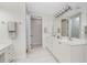 Bright bathroom features double vanity, white cabinets, and tiled floor at 2630 Tarpon Cove Dr # 211, Punta Gorda, FL 33950