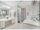 Bright bathroom with double vanity, white cabinets, and a separate shower at 2630 Tarpon Cove Dr # 211, Punta Gorda, FL 33950