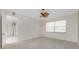 Bedroom with wood-look flooring, ceiling fan, and natural light at 2630 Tarpon Cove Dr # 211, Punta Gorda, FL 33950