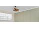 Bedroom featuring wood flooring, a ceiling fan, and a window at 2630 Tarpon Cove Dr # 211, Punta Gorda, FL 33950