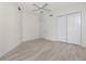 Well lit bedroom with a ceiling fan and light wood-look flooring and closet at 2630 Tarpon Cove Dr # 211, Punta Gorda, FL 33950