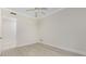 Clean, neutral bedroom featuring a ceiling fan and a doorway to another room at 2630 Tarpon Cove Dr # 211, Punta Gorda, FL 33950
