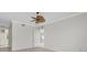 Bright bedroom with ceiling fan, white trim, and light wood-look floors at 2630 Tarpon Cove Dr # 211, Punta Gorda, FL 33950
