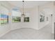 Eat-in kitchen features tile floors, three windows, and a chandelier at 2630 Tarpon Cove Dr # 211, Punta Gorda, FL 33950