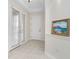 Bright hallway featuring tile flooring, neutral walls, and a decorative painting for an elegant touch at 2630 Tarpon Cove Dr # 211, Punta Gorda, FL 33950