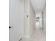 Clean hallway with tile floors, neutral paint, and an open view to a bright, spacious room at 2630 Tarpon Cove Dr # 211, Punta Gorda, FL 33950