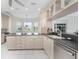 Spacious kitchen with white cabinets, stainless steel appliances, and granite countertops at 2630 Tarpon Cove Dr # 211, Punta Gorda, FL 33950