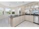 Bright eat-in kitchen features white cabinets, stainless appliances, and ample counter space at 2630 Tarpon Cove Dr # 211, Punta Gorda, FL 33950