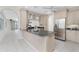 Open kitchen featuring a breakfast bar, stainless steel appliances, and an arched entryway at 2630 Tarpon Cove Dr # 211, Punta Gorda, FL 33950