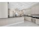Spacious kitchen featuring custom cabinets, black countertops, and stainless steel appliances at 2630 Tarpon Cove Dr # 211, Punta Gorda, FL 33950